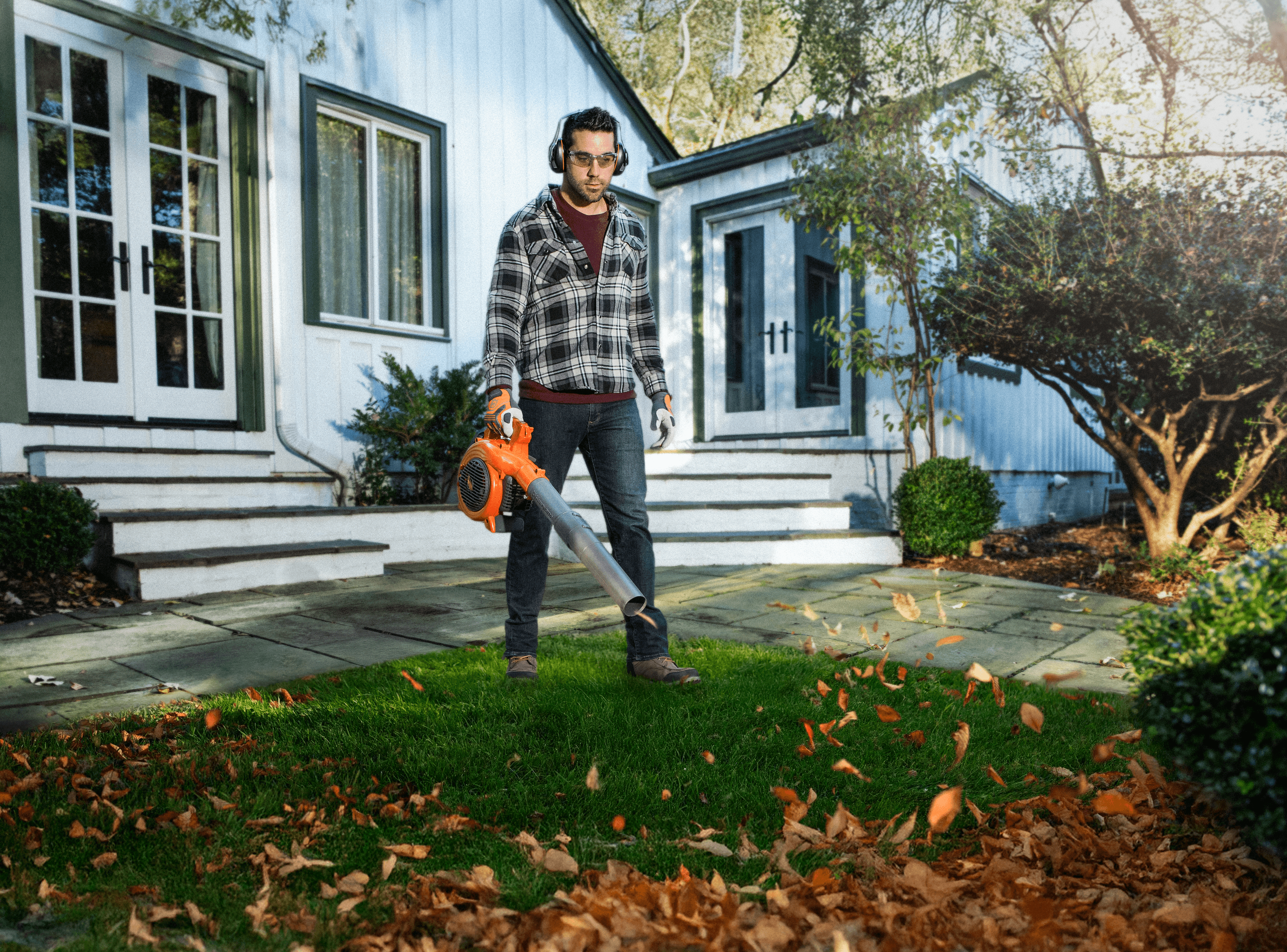 man wearing ppe with chainsaw